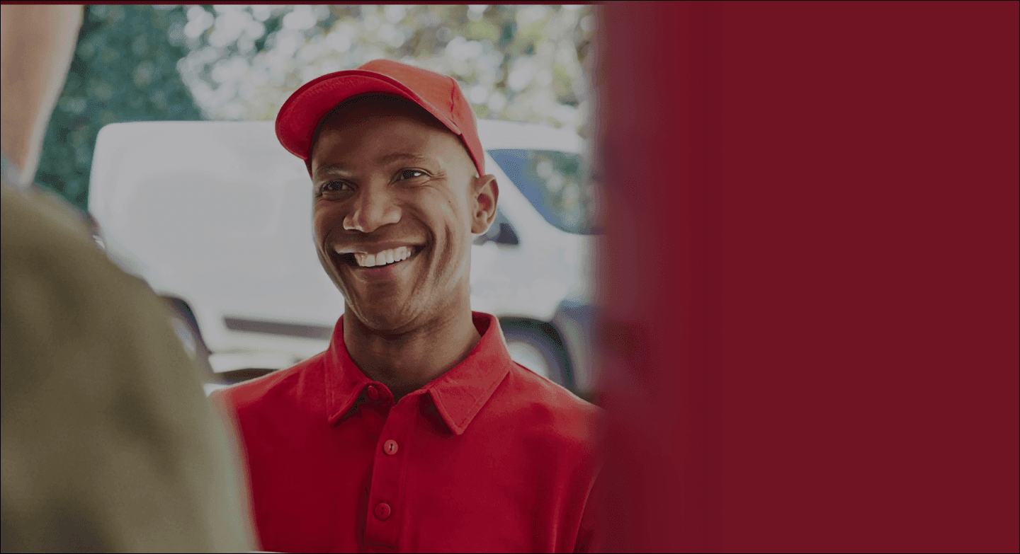 Smiling mover in red uniform